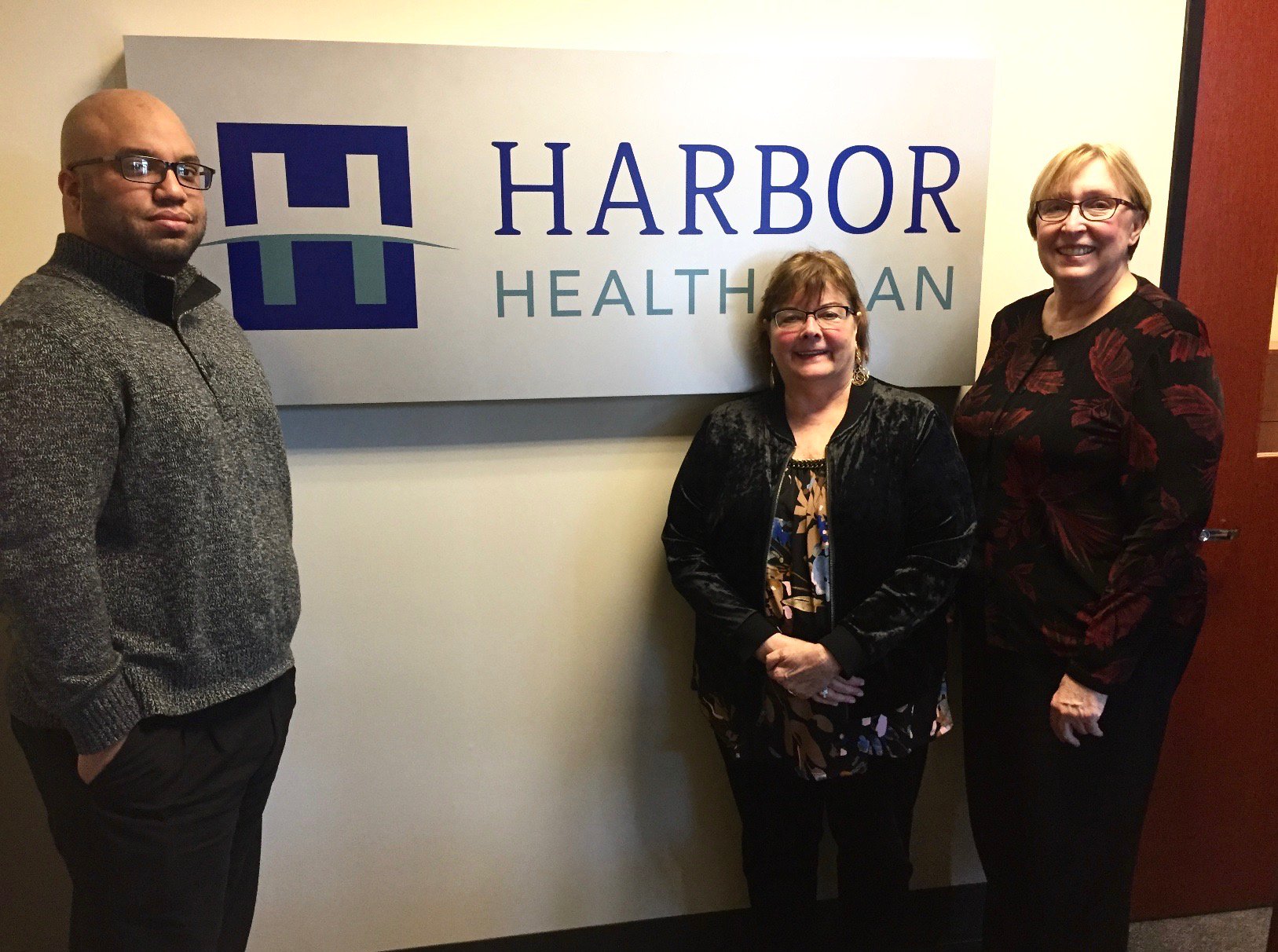 Harbor Health employees in front of Harbor Health sign